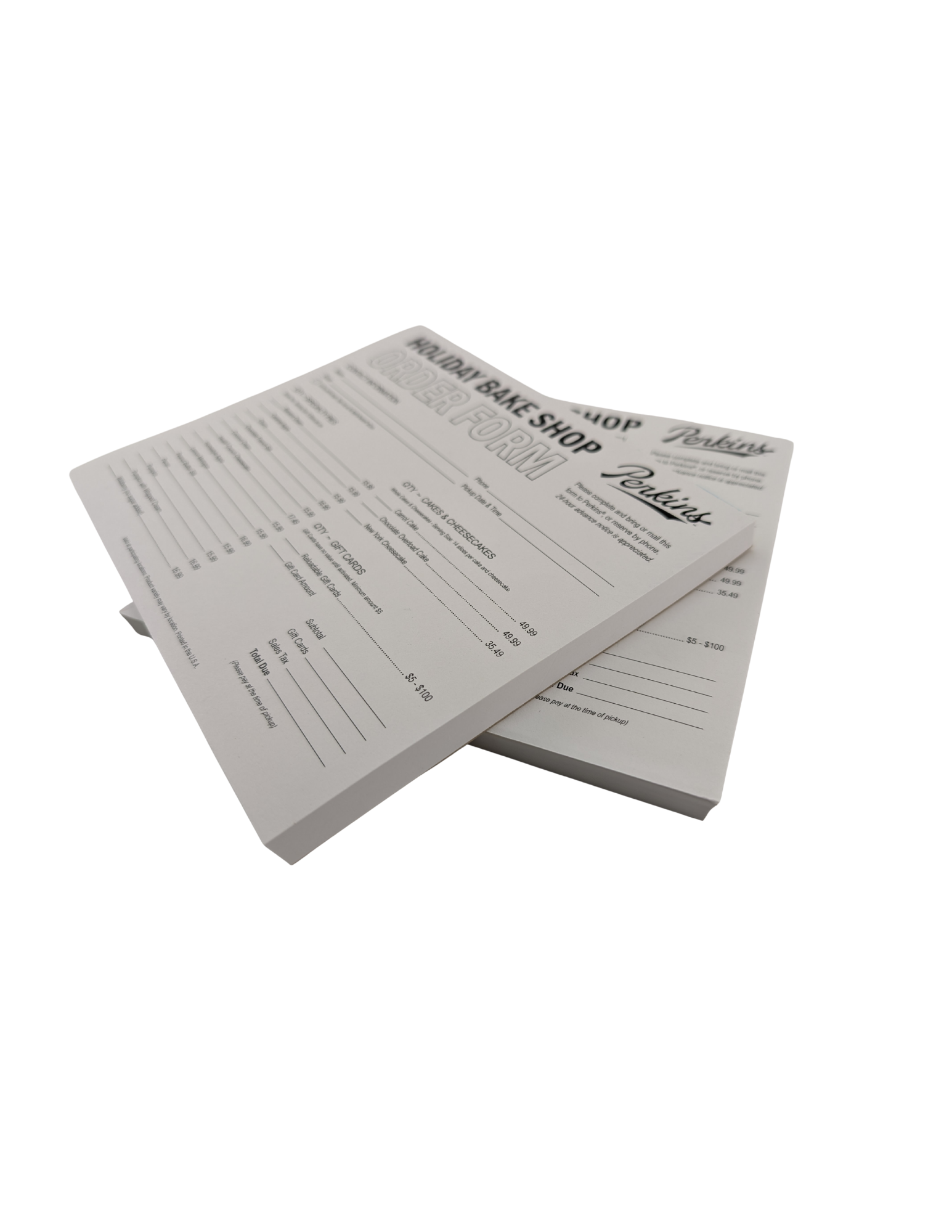 Two stacks of white order forms from a bake shop, with printed black text and lines.