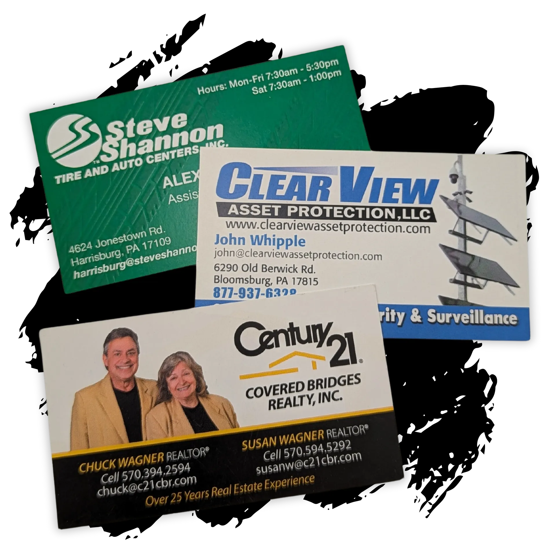 Several business cards are stacked on top of each other including one for century 21