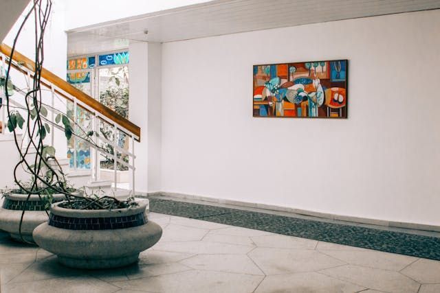There is a painting on the wall above the stairs.