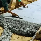 Concrete contractors pouring and leveling walkway, linked to Hutt City and Upper Hutt Councils.