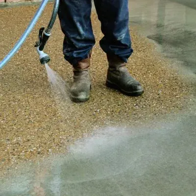 Contractor washing exposed aggregate walkway and patio in Boulcott, Lower Hutt.