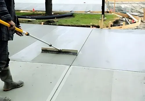 Driveway contractors are brushing finished concrete on a large construction project in Hutt City.