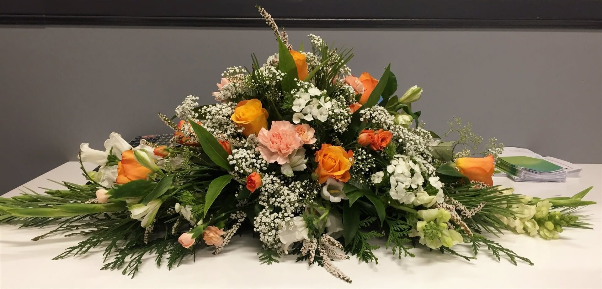 Floral Arrangement With Orange, Peach, and White Flowers — Finlayson & McKenzie Funeral Directors in Rockhampton City, QLD