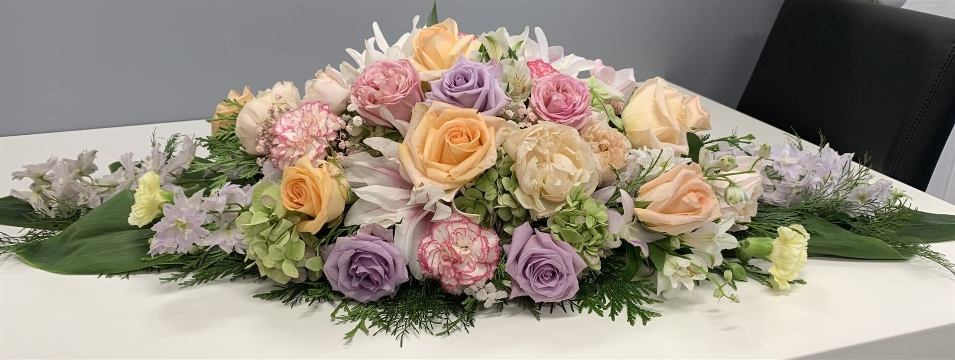 A Low Arrangement of Pastel-coloured Flowers — Finlayson & McKenzie Funeral Directors in Rockhampton City, QLD