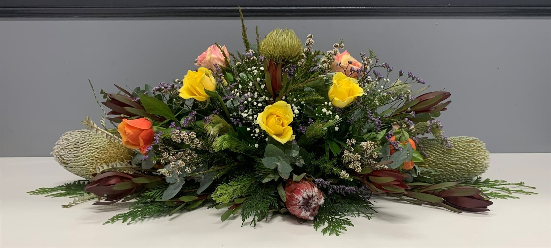 Floral Arrangement of Yellow and Orange Roses — Finlayson & McKenzie Funeral Directors in Rockhampton City, QLD
