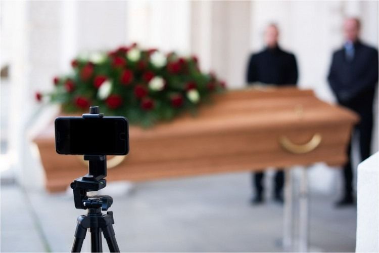 A Smartphone on a Tripod Recording a Funeral — Finlayson & McKenzie Funeral Directors in Rockhampton City, QLD