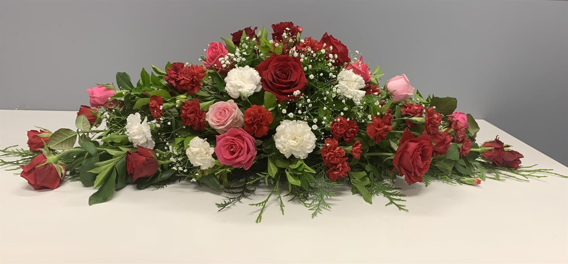 Floral Arrangement of Red, Pink, and White Roses — Finlayson & McKenzie Funeral Directors in Rockhampton City, QLD