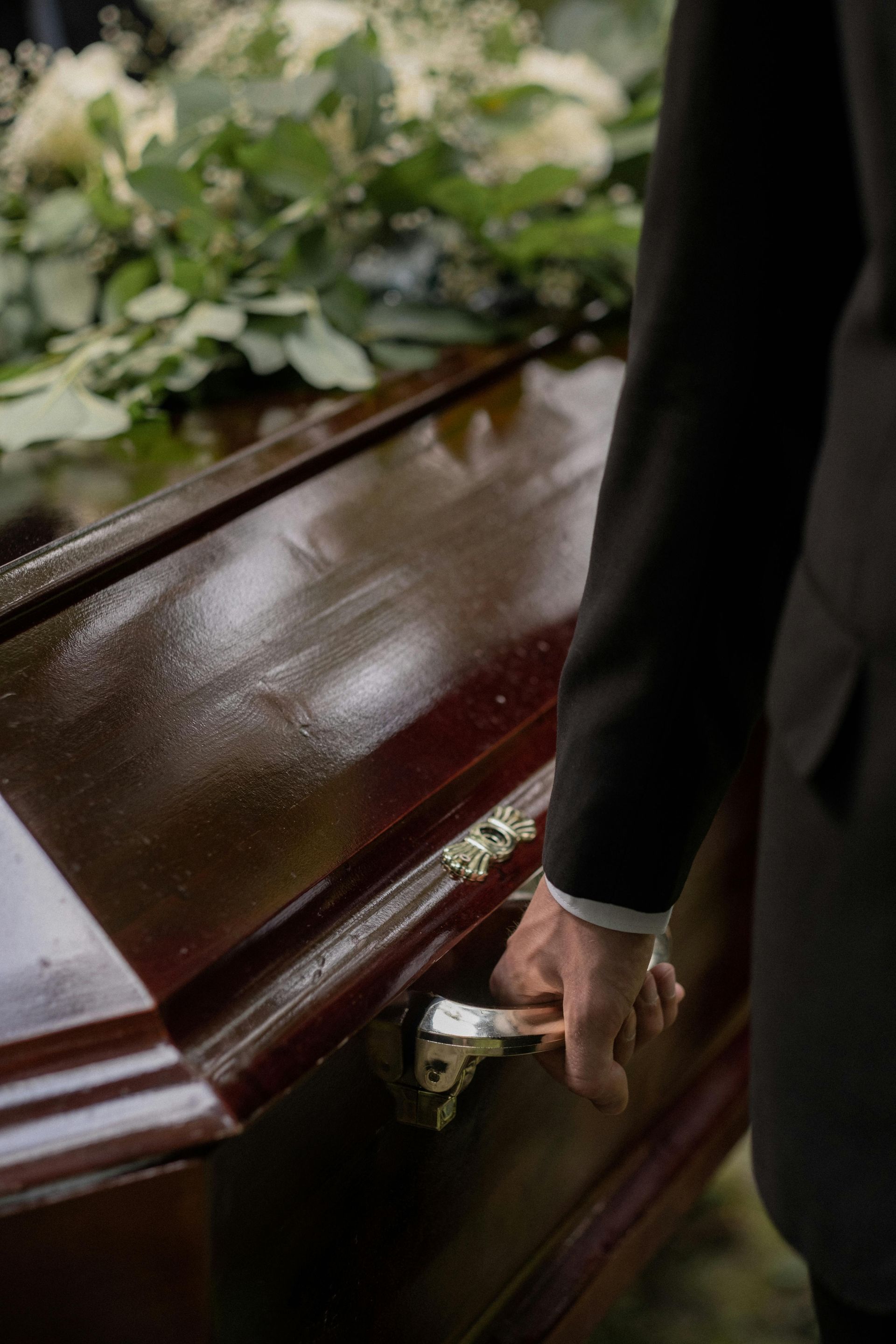 Wooden Casket in a Hearse — Finlayson & McKenzie Funeral Directors in Rockhampton City, QLD