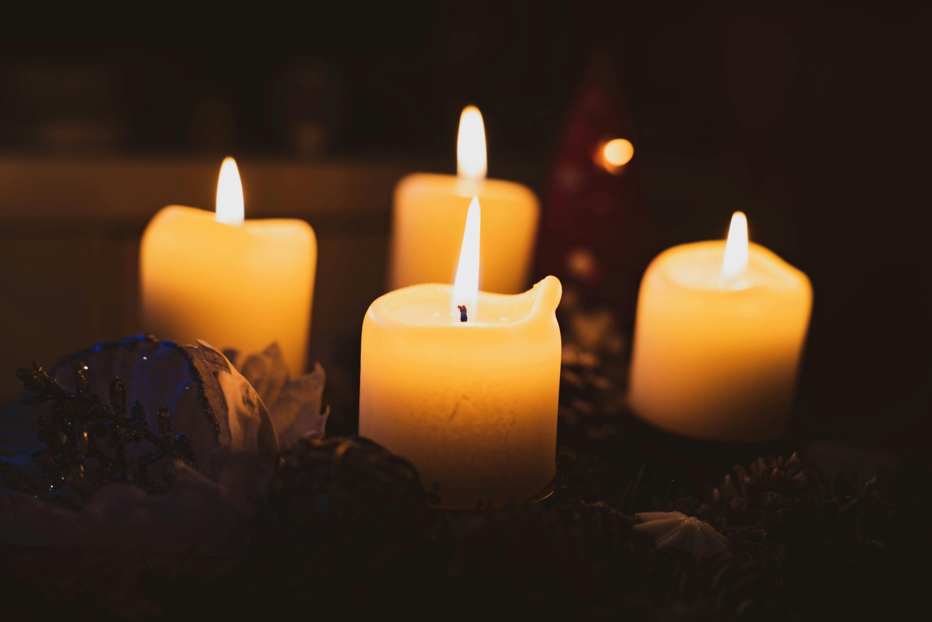 Candlelit Votives in Glass Holders, Blurred Background — Finlayson & McKenzie Funeral Directors in Rockhampton City, QLD