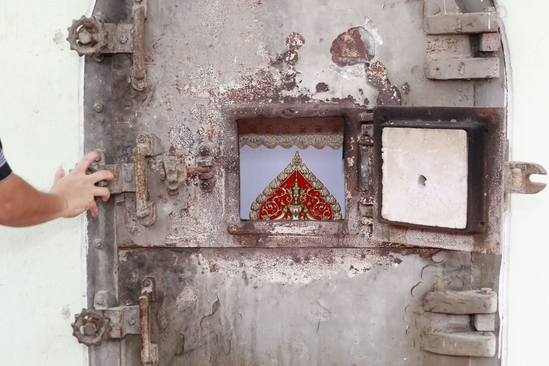 Rusty Metal Crematorium Door With Viewing Window — Finlayson & McKenzie Funeral Directors in Yeppoon, QLD