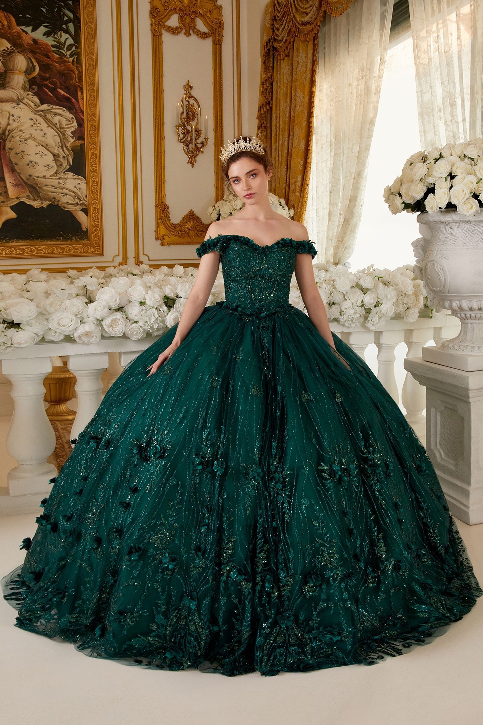 A woman is wearing a green ball gown and a tiara.