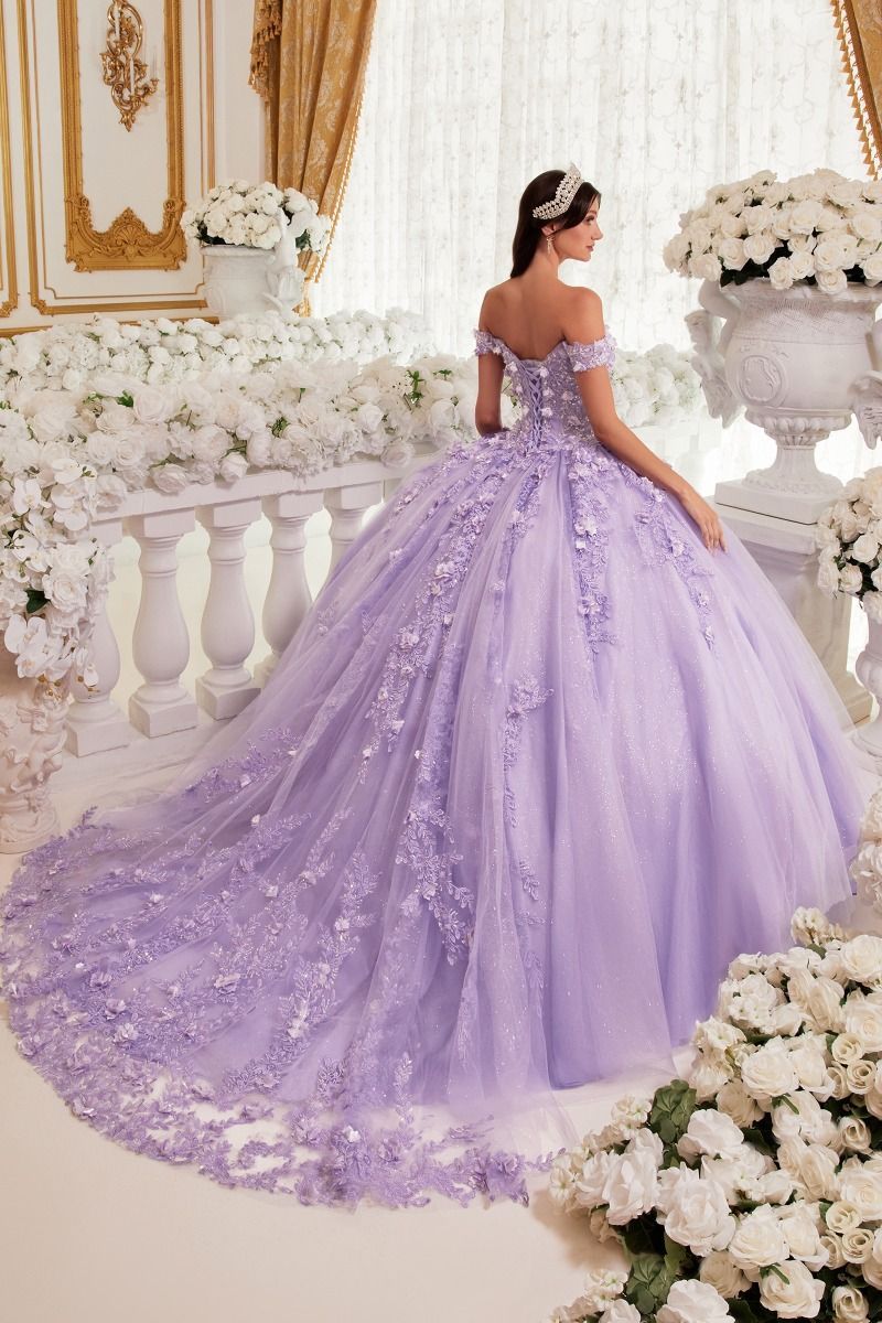 A woman is wearing a purple ball gown with a long train.