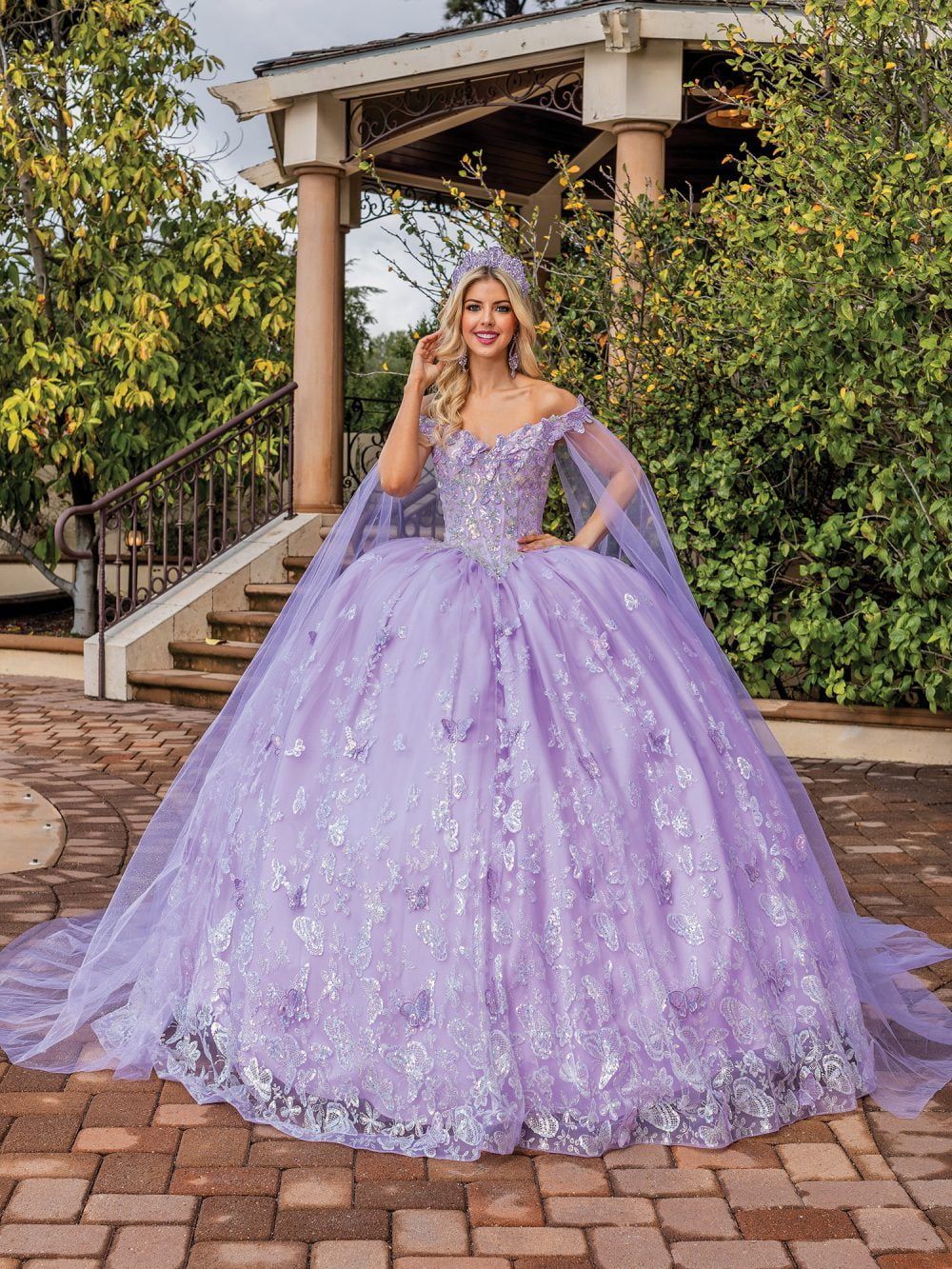 A woman is wearing a purple ball gown with a cape.
