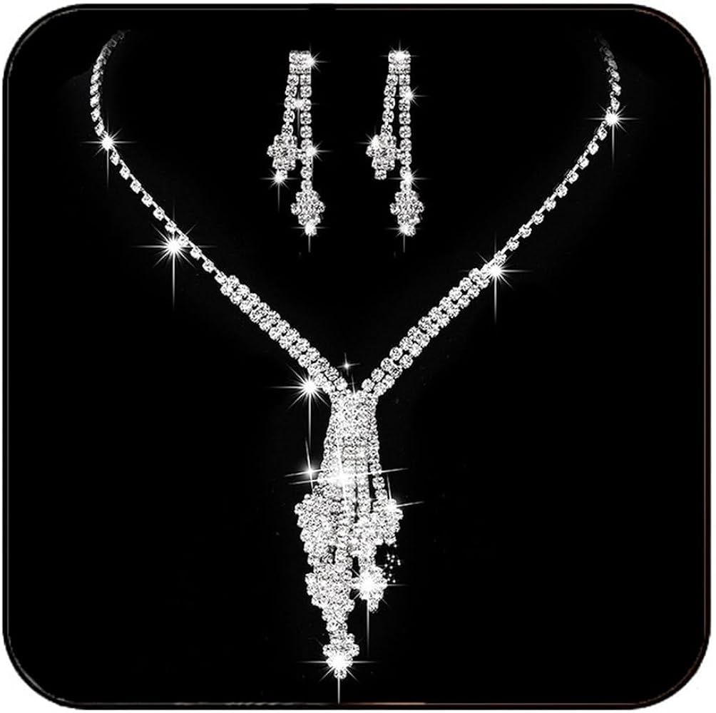 A necklace and earring set with rhinestones on a black background.