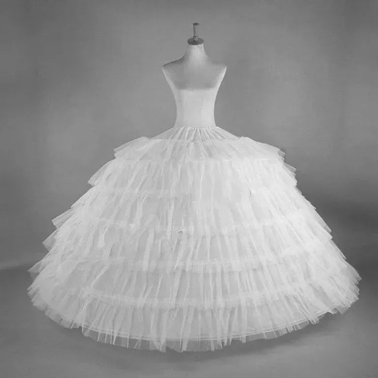 A black and white photo of a white dress on a mannequin.