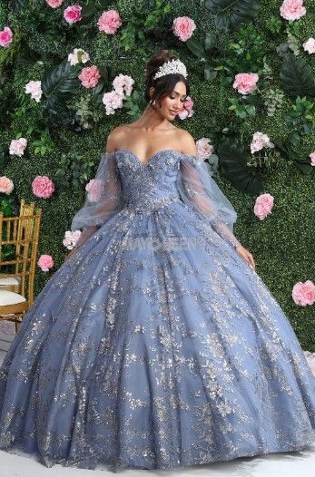 A woman is wearing a blue ball gown and a tiara.