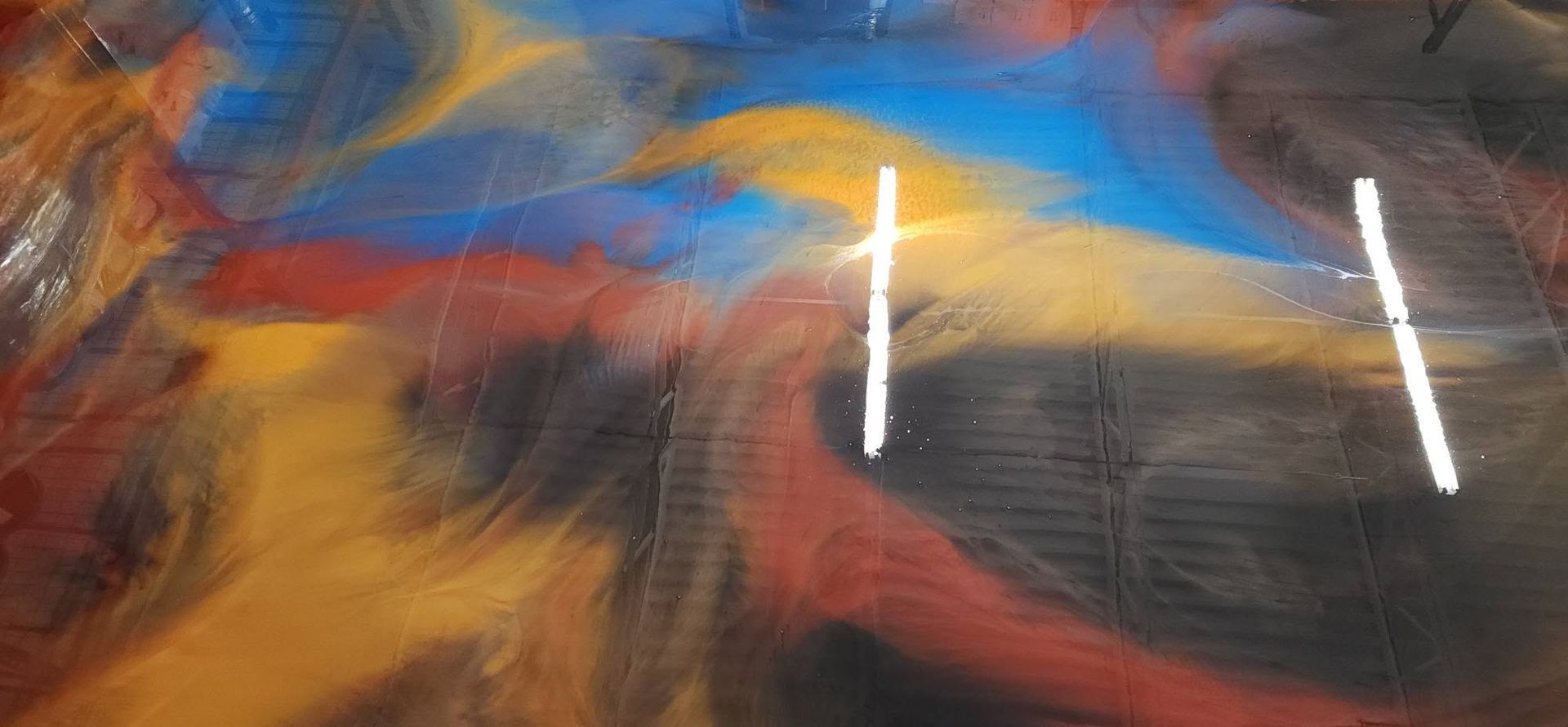 Abstract colorful painting with blue, orange, and yellow brushstrokes and bright white light reflections