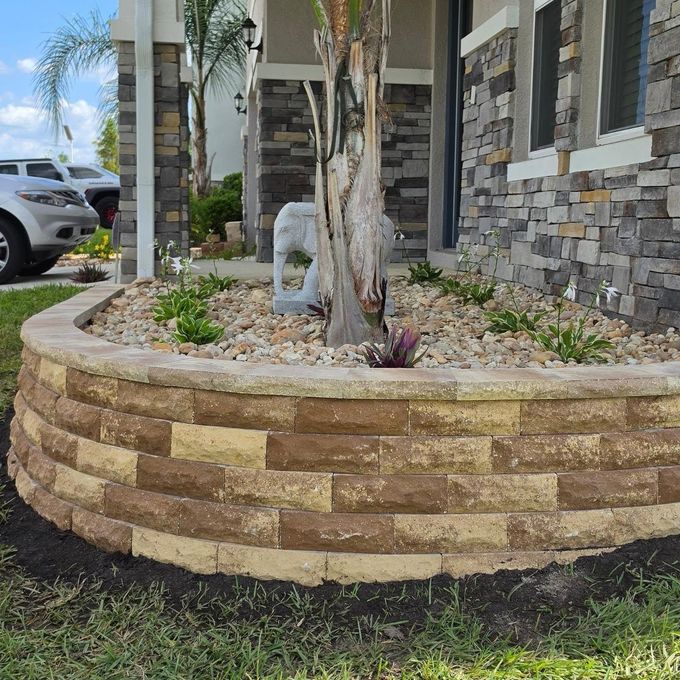 Completed custom paver retaining wall at a Lakeland FL residential property by New Era Landscaping.