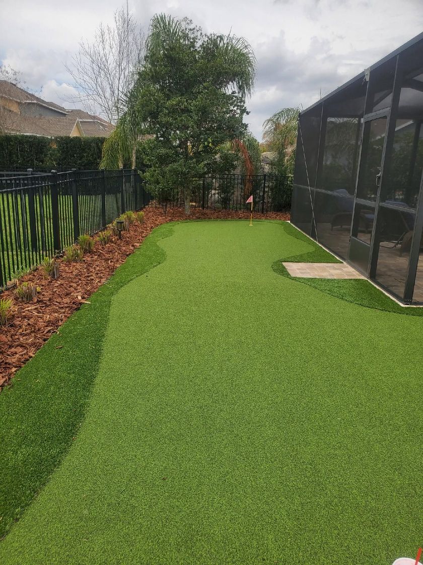 Finished decorative concrete curbing along a garden bed at a Lakeland, FL residential property by New Era Landscaping.