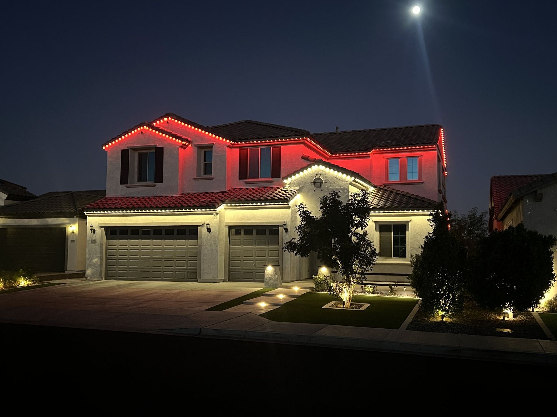 Permanent TruLight holiday lighting with red and warm white roofline lights Permanent TruLight holiday lighting with red and warm white roofline lights