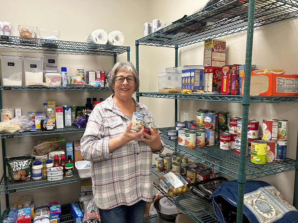 Woman filling a food pantry as volunteer work