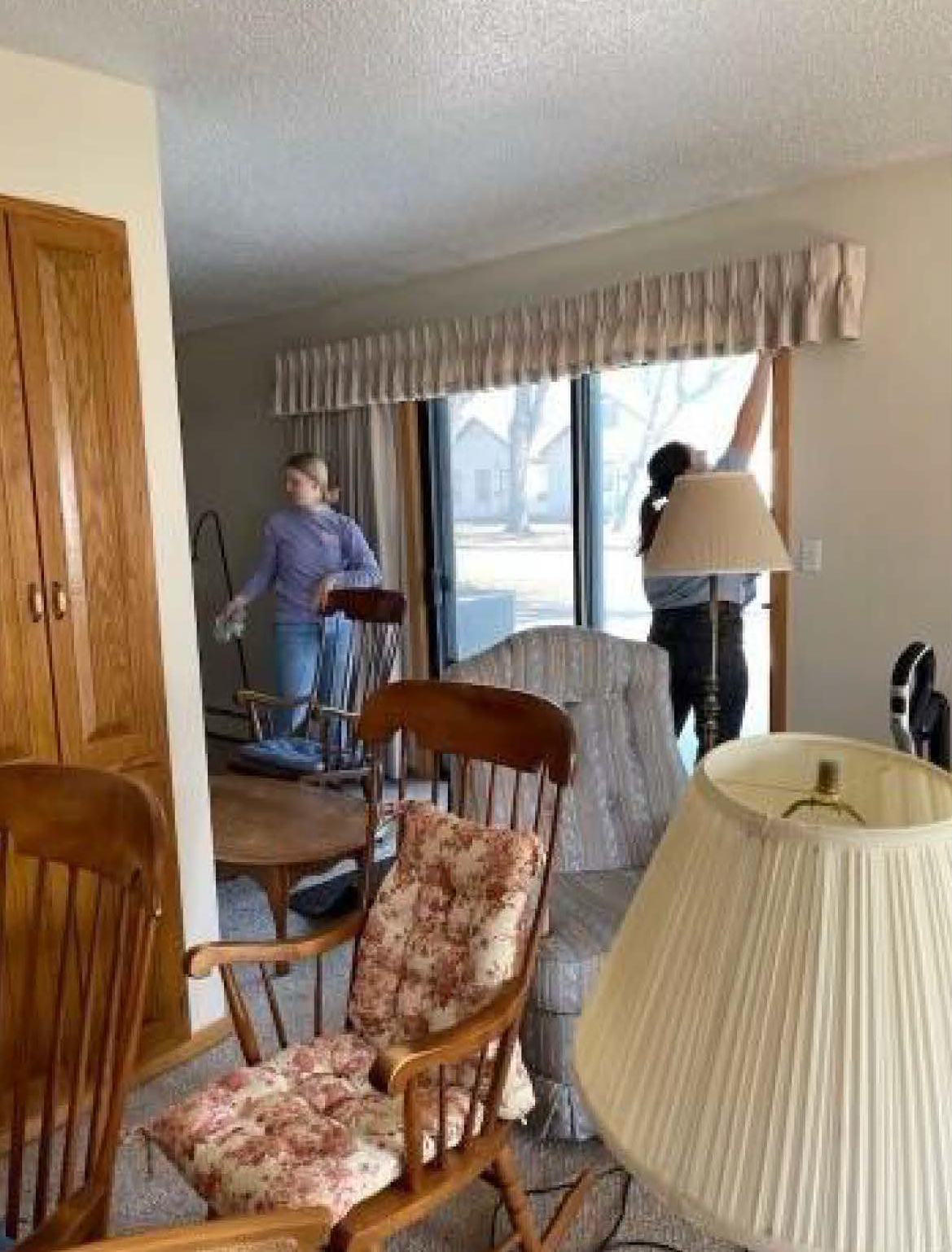 student volunteers hanging curtains