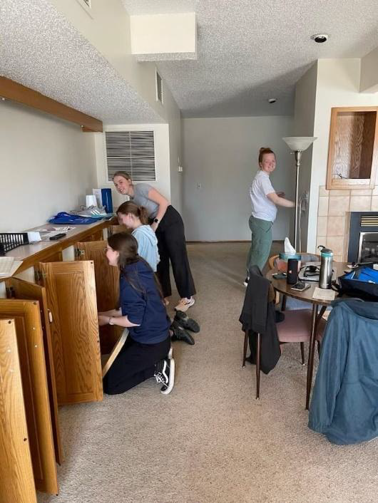 student volunteers putting cabinets together