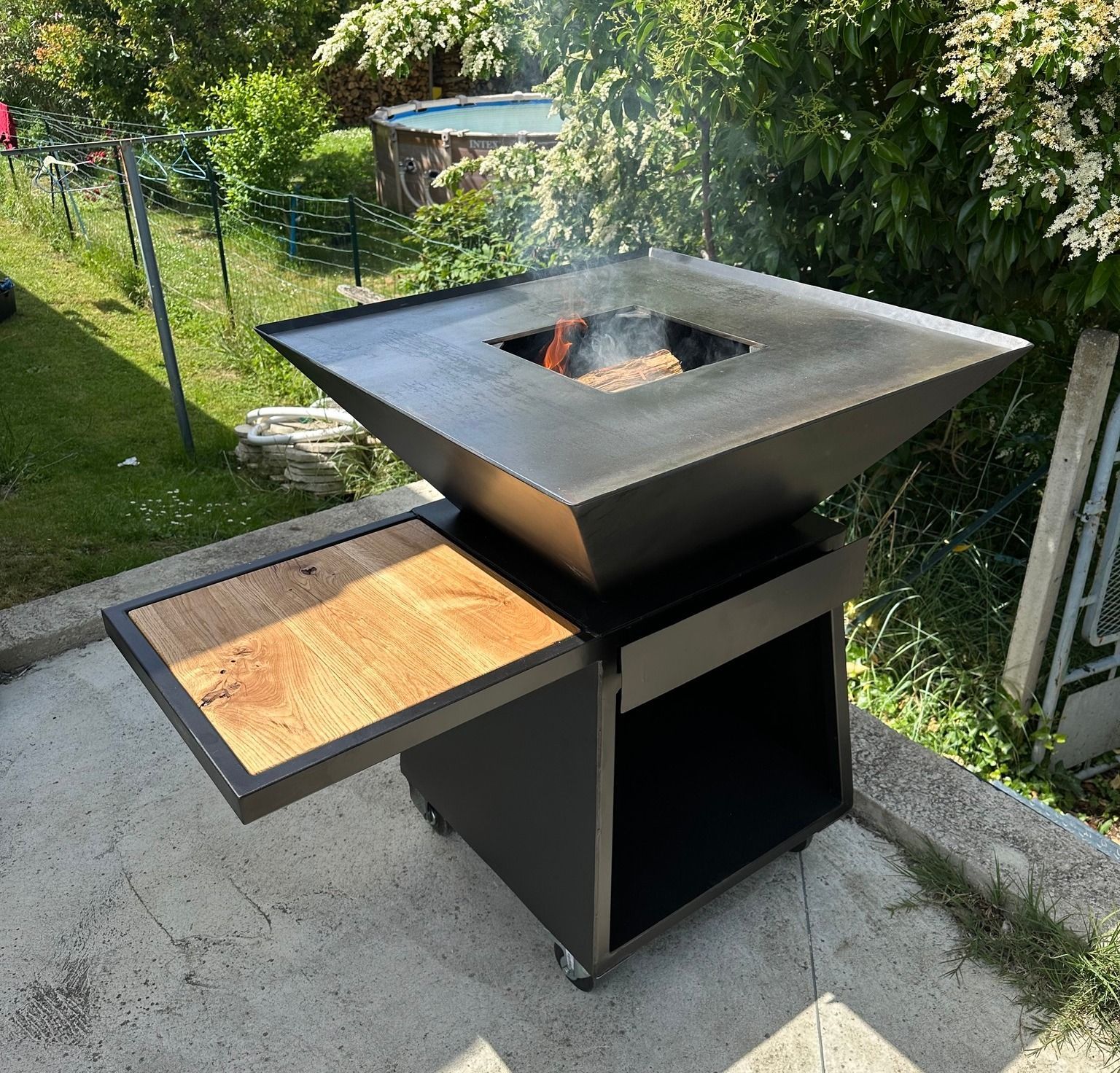 Brasero noir avec une surface en bois