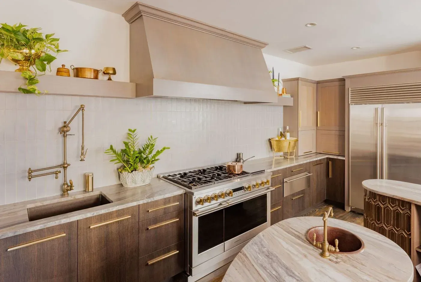 A kitchen with stainless steel appliances , wooden cabinets , a sink and a stove.