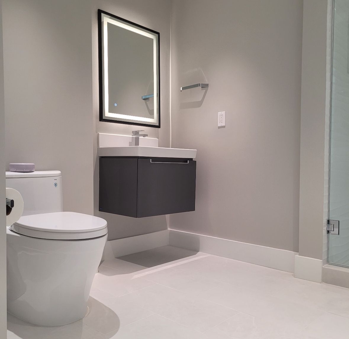 Modern bathroom with gray tiled walls