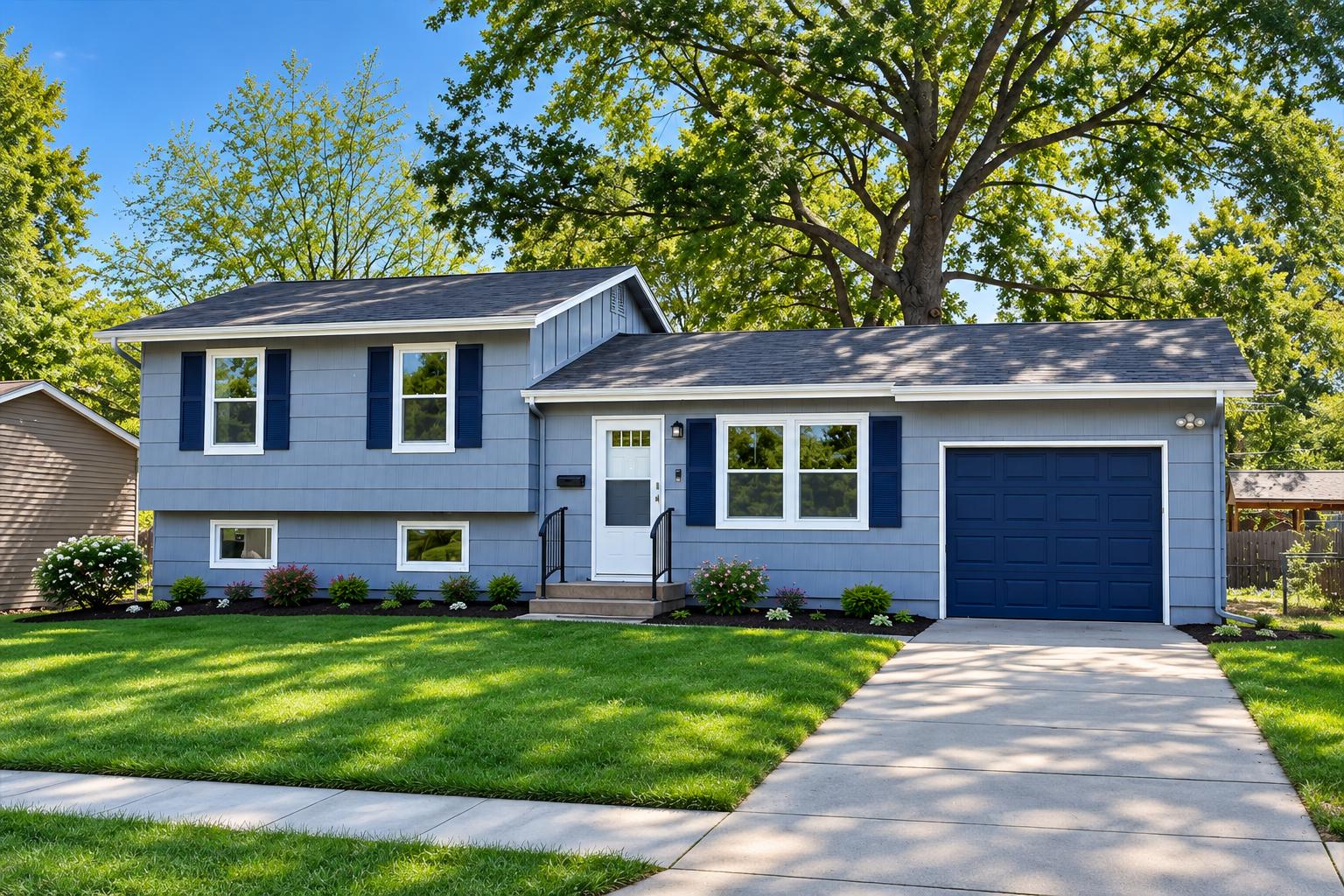 Blue two-story house on a tree-lined street in Downtown Lee's Summit, MO