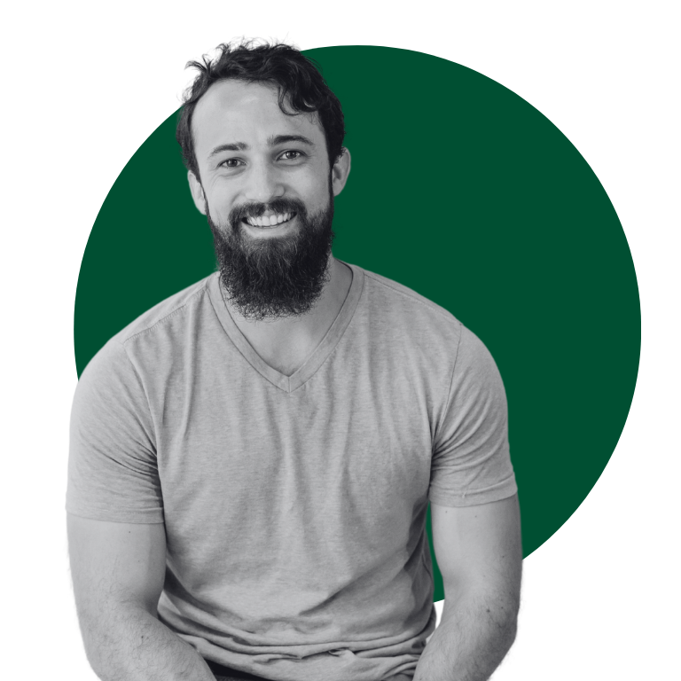 A man is standing in front of a green circle.