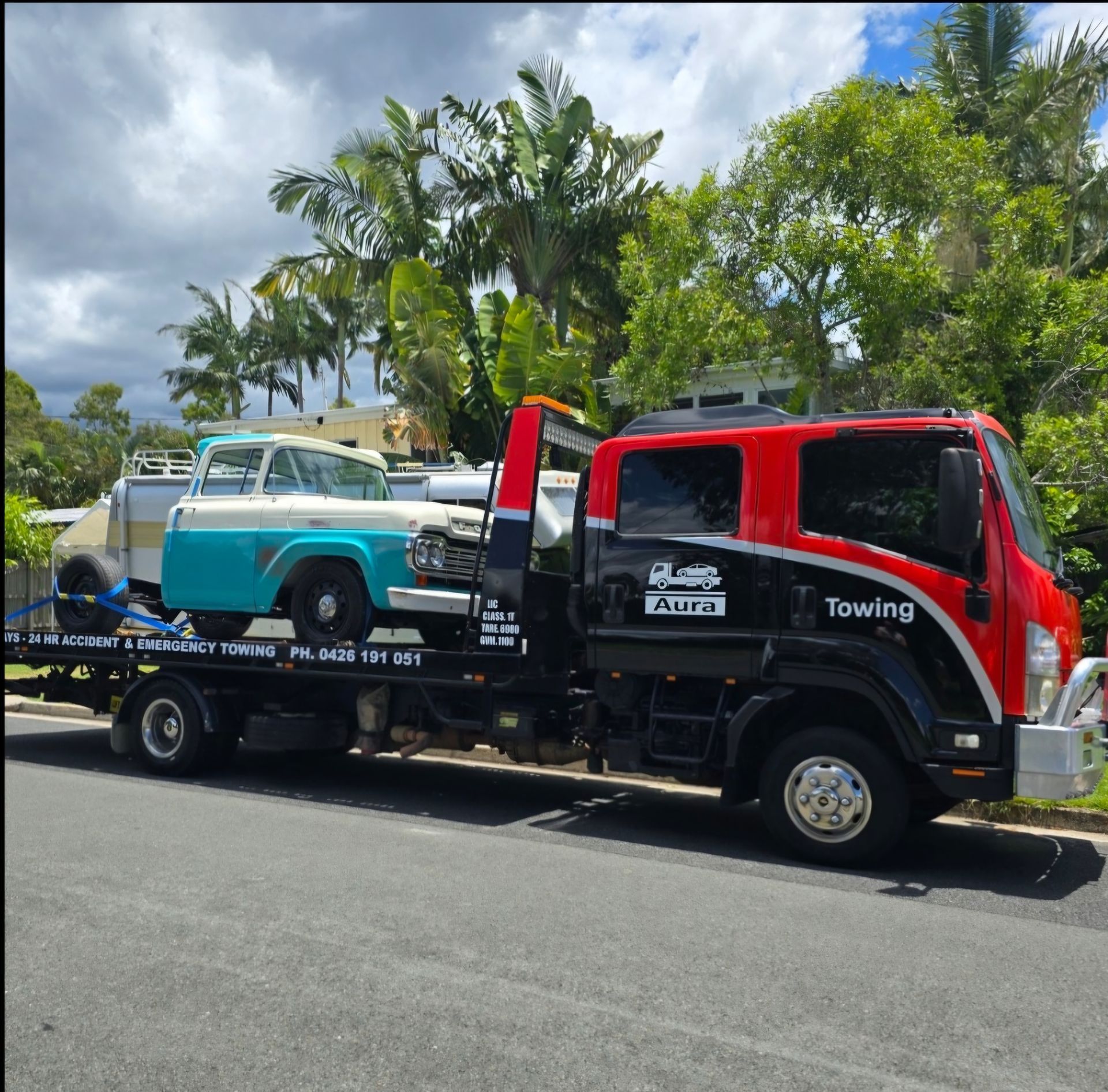 A Car is Being Towed by a Tow Truck — Aura Towing Service in Baringa, QLD 