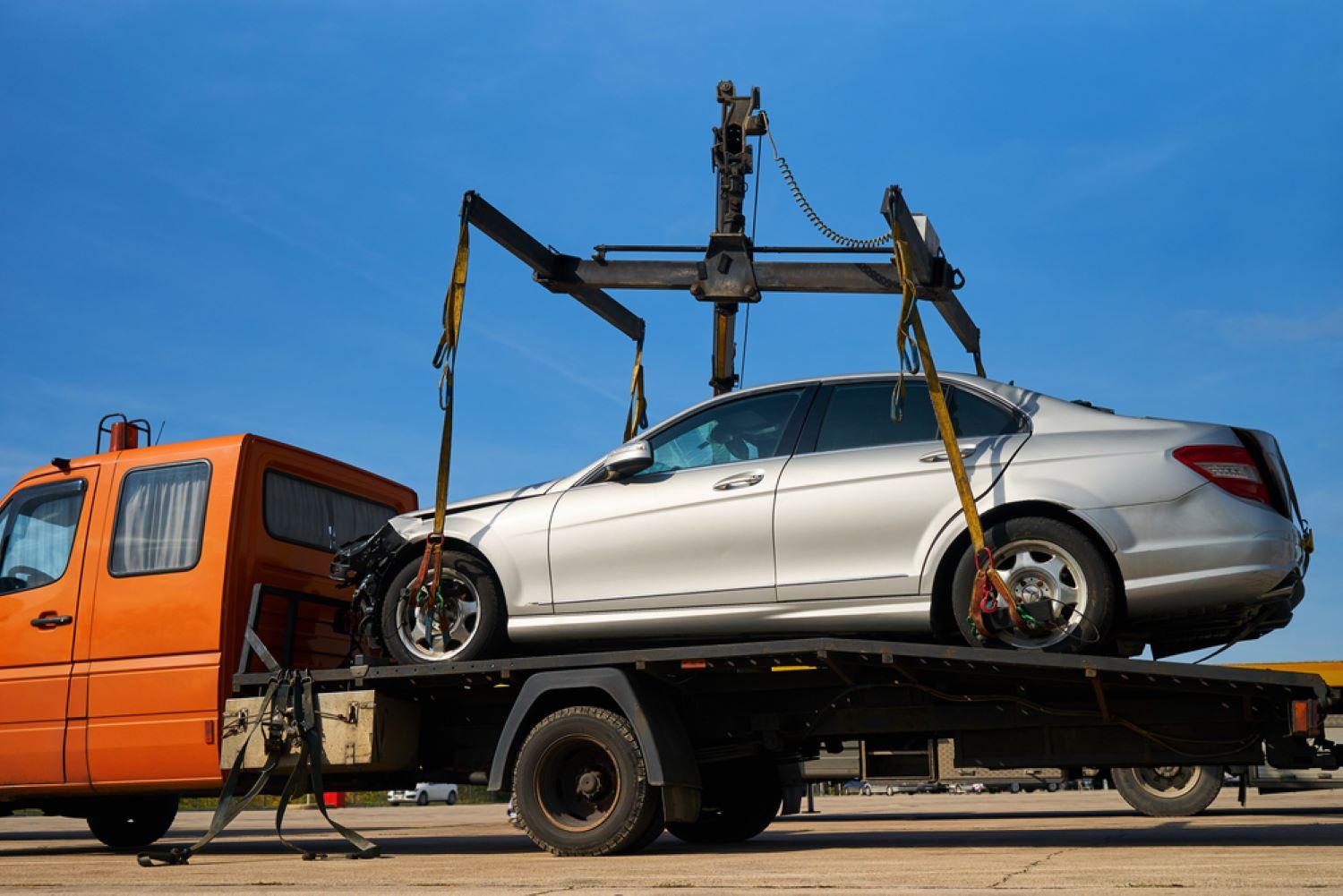 A White Car is Being Towed by a Tow Truck — Aura Towing Service in Baringa, QLD