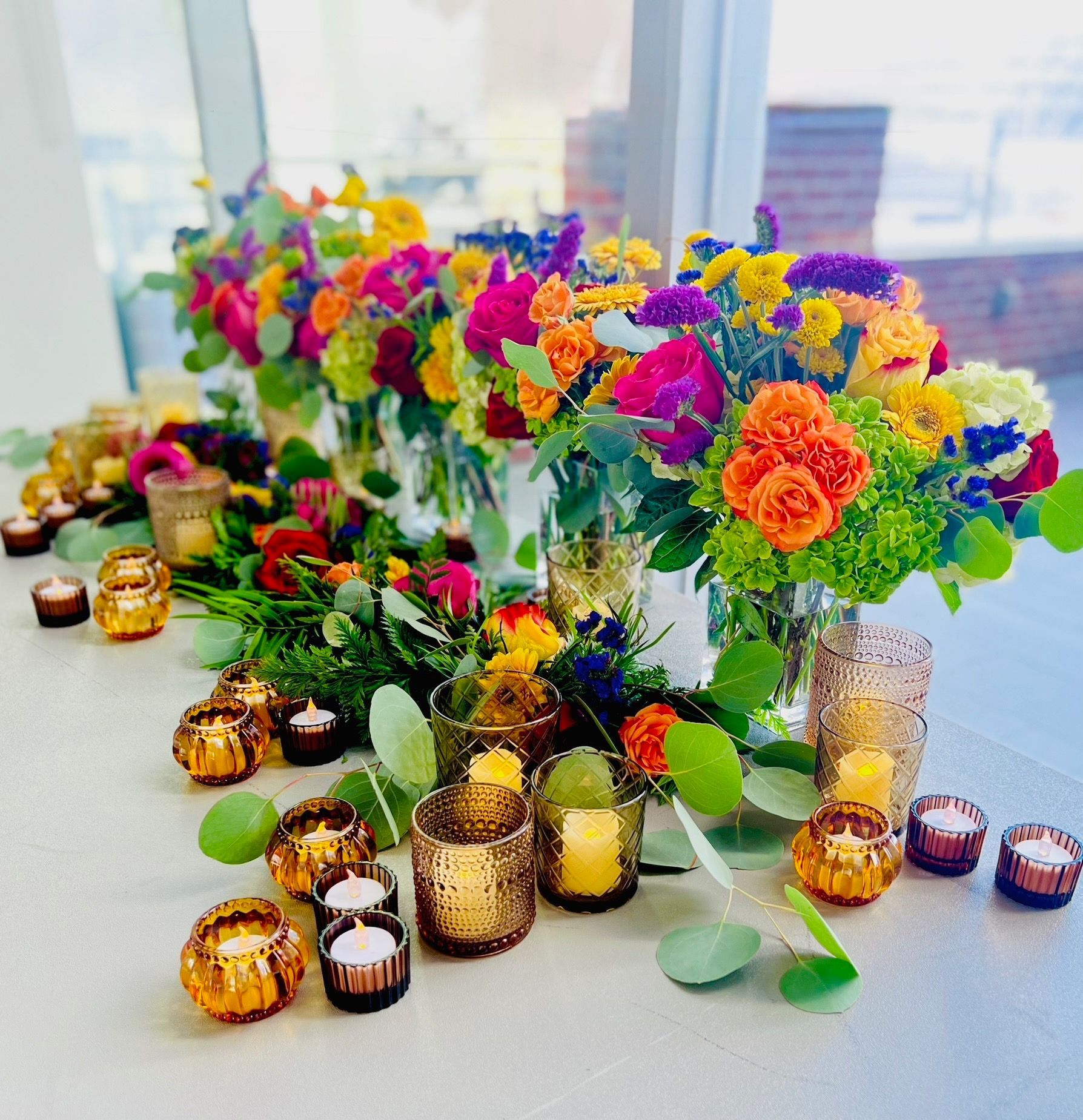 Las Vegas corporate Bright colorful corporate arrangements, amber votive candles