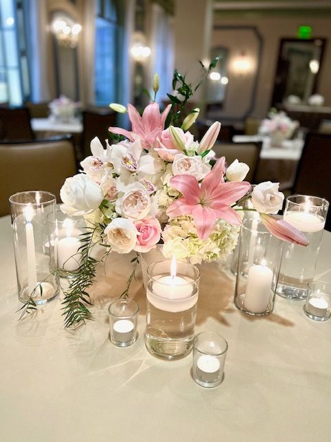 Pink and white flowers, floating candles for wedding reception