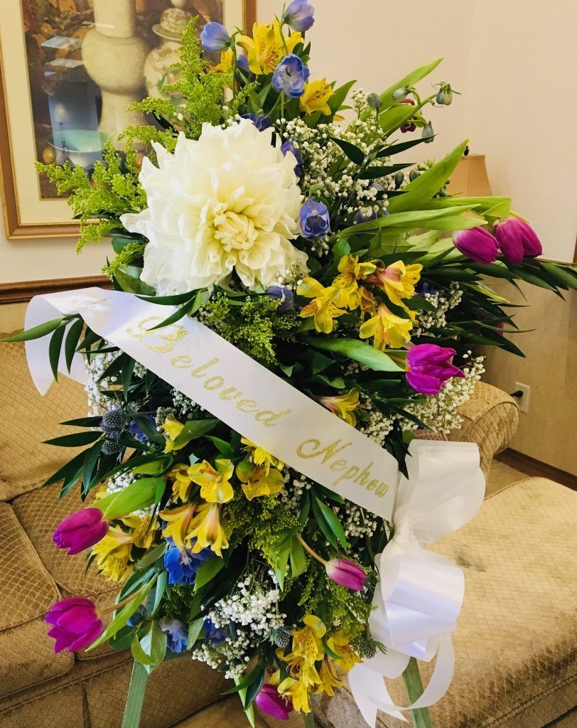 A bouquet of flowers with a ribbon that says