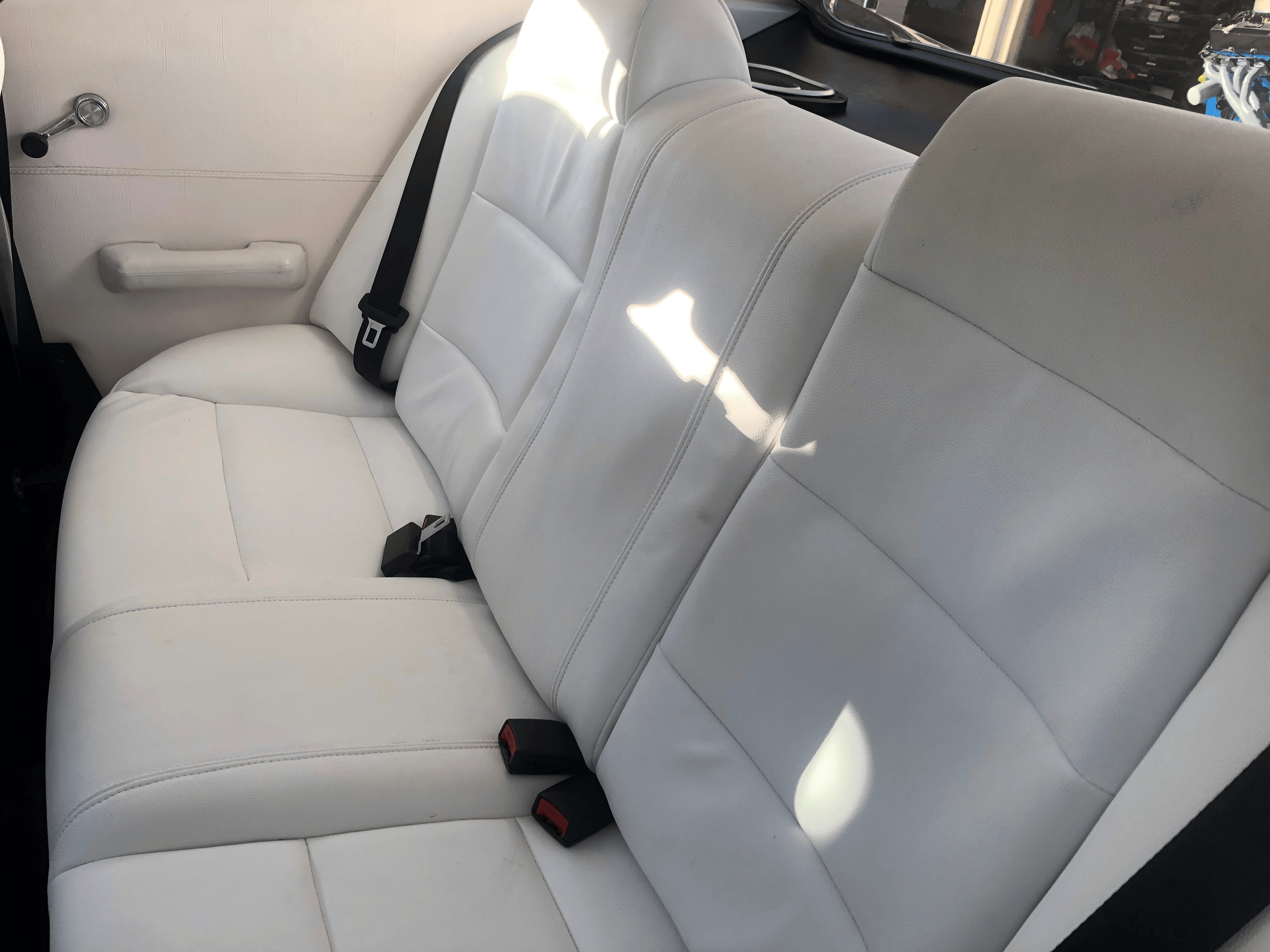 A Car With The Door Open With All White Car Seats — Simmons Glass & Trim In Bathurst, NSW