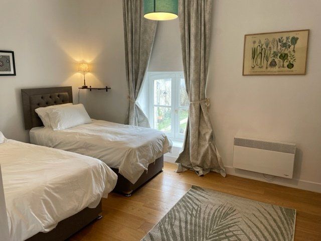 Bedroom in our Mirabelle cottage with 2 single beds that can be zipped to form one larges 180x200cm bed