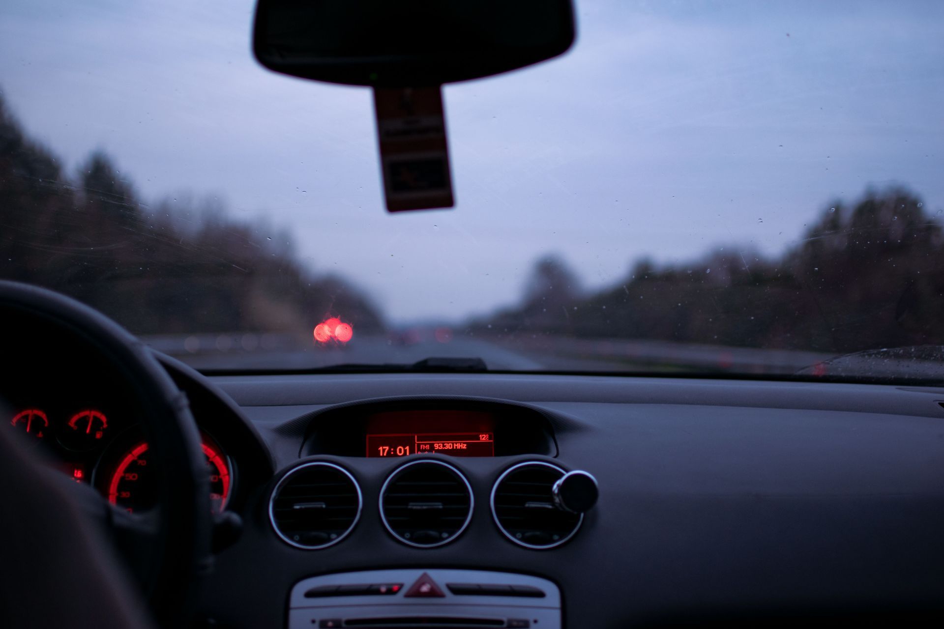 Driving view through a car windshield on an Arizona road with AmShield car insurance coverage