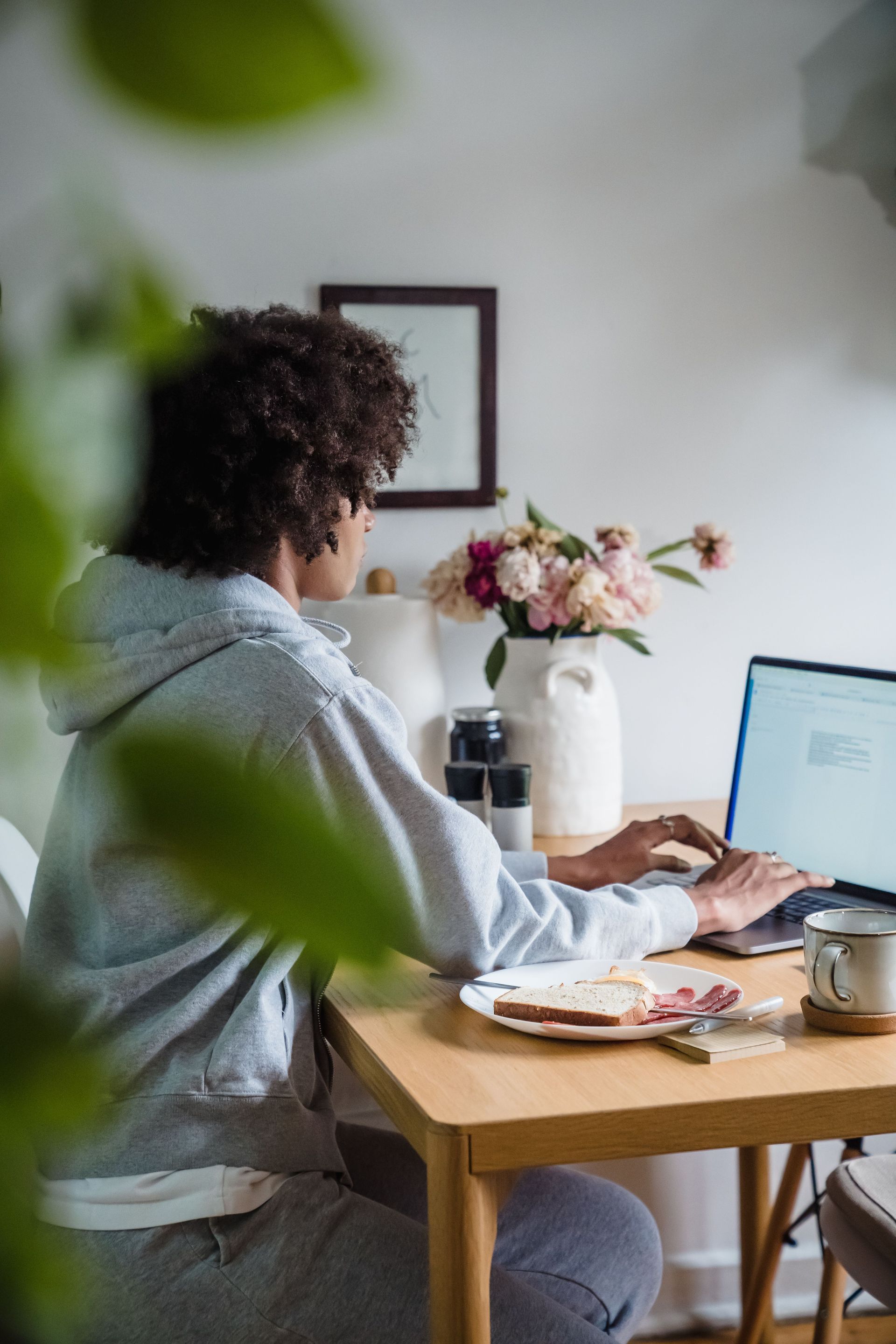 Remote worker at a home desk in Arizona driving fewer miles and earning low mileage car insurance savings