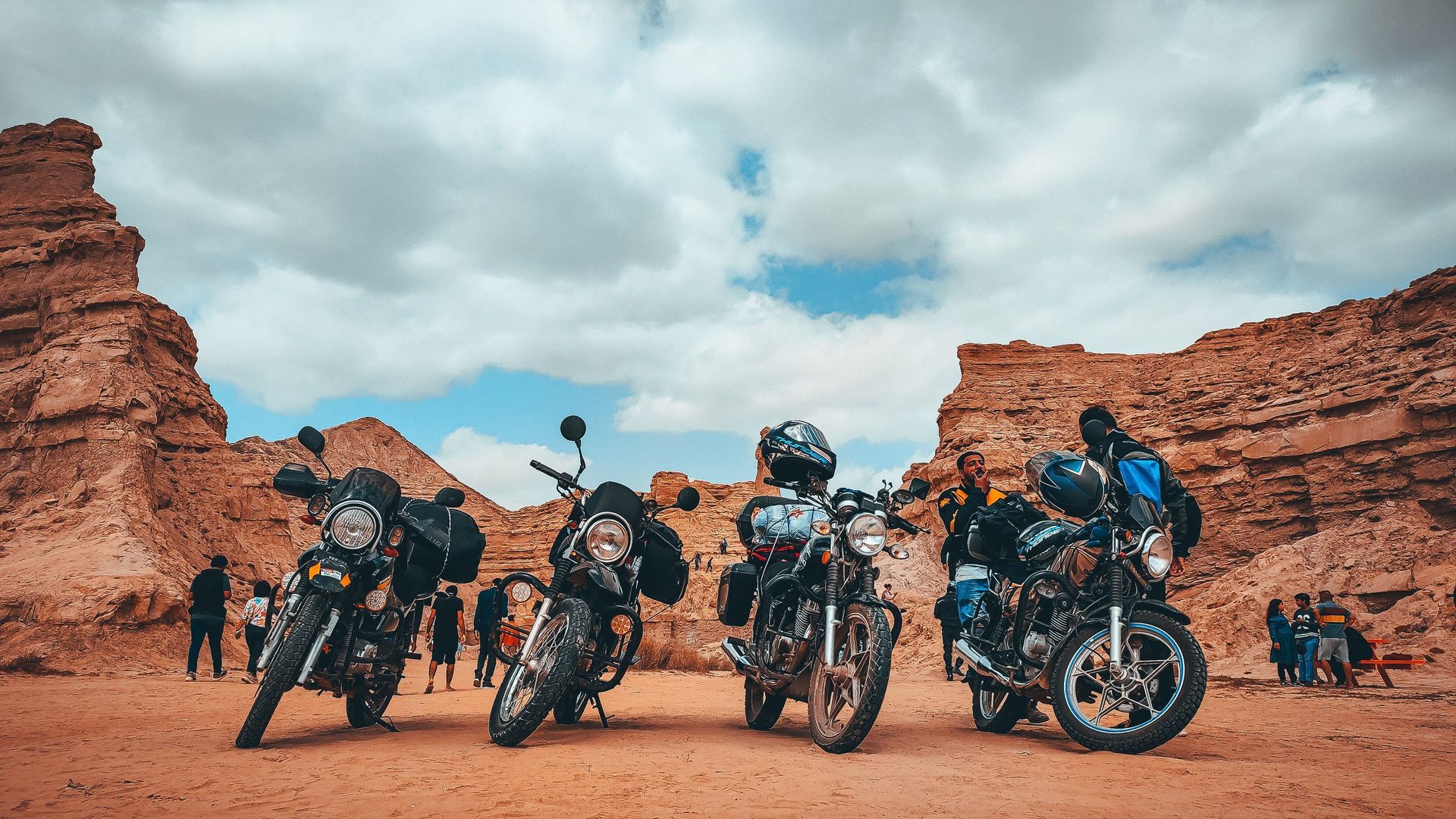 Group of motorcycles parked in a red rock Arizona desert canyon