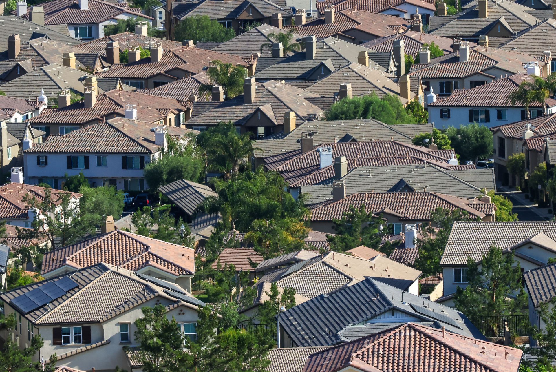 Aerial view of a Mesa Arizona suburban neighborhood with tile roof homes and mature trees