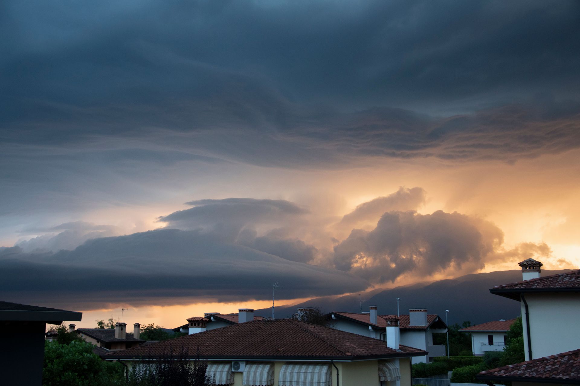 Storm clouds and sunset over Phoenix area Arizona homes after a monsoon hailstorm