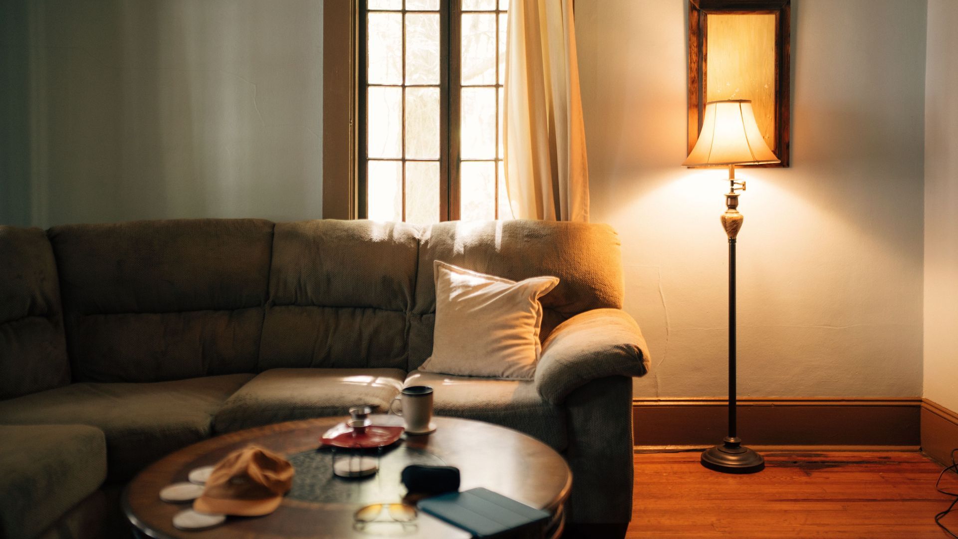 Furnished living room with sofa and lamp showing belongings covered by personal property insurance