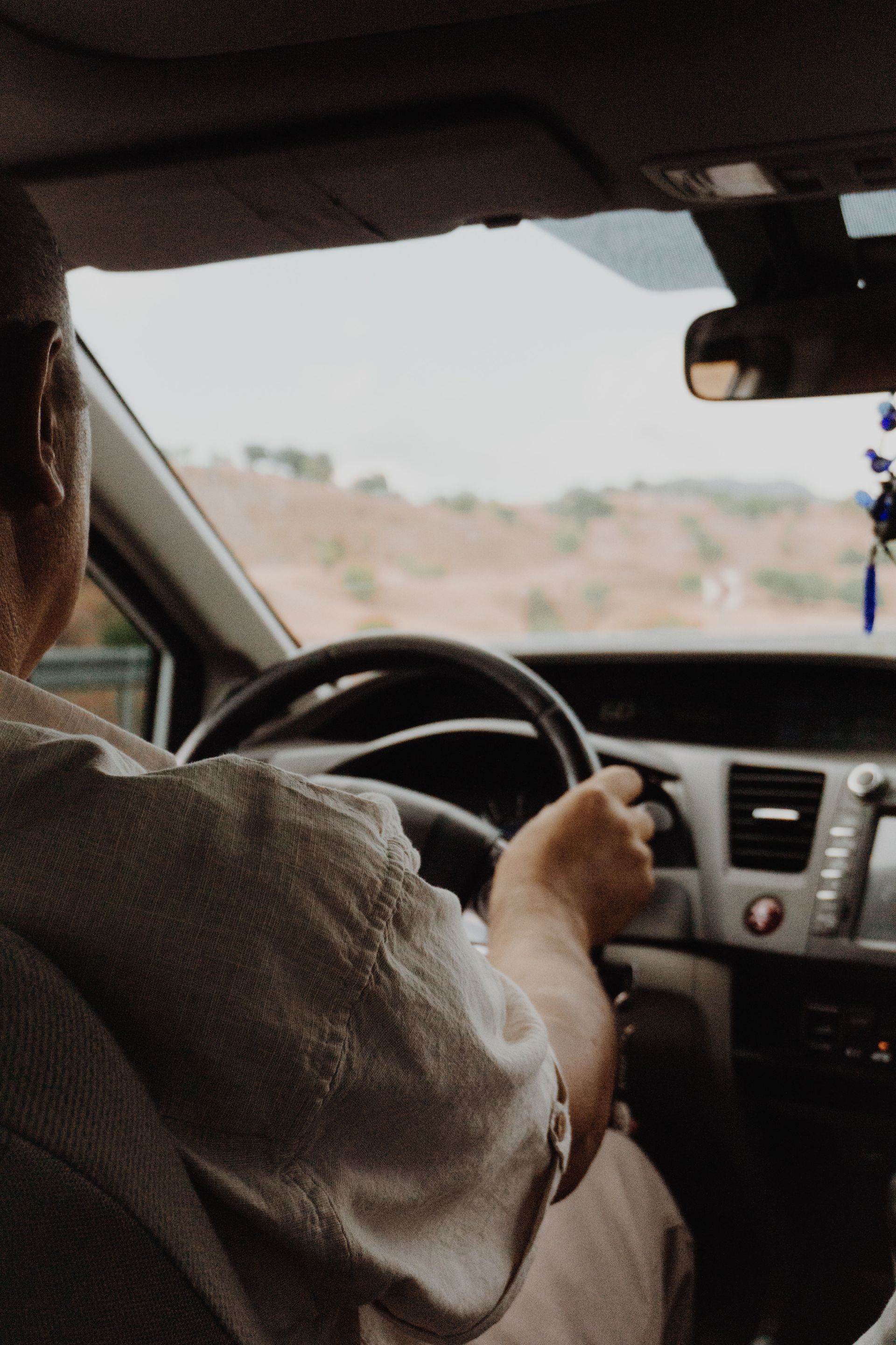 Peoria AZ driver behind the wheel on a West Valley road, illustrating local car insurance coverage needs