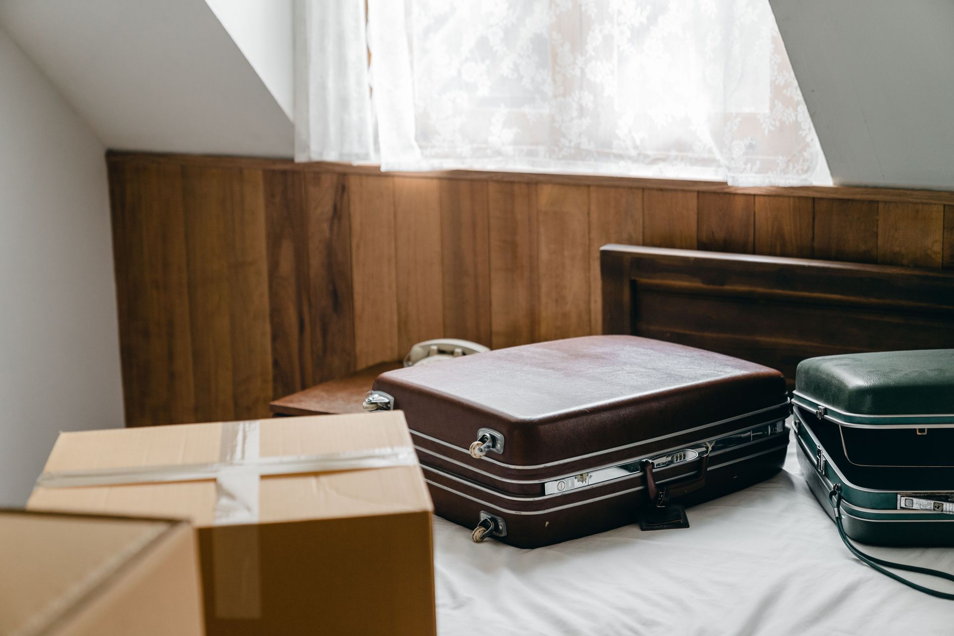 Packed suitcases and boxes in a quiet Arizona seasonal home before a long absence