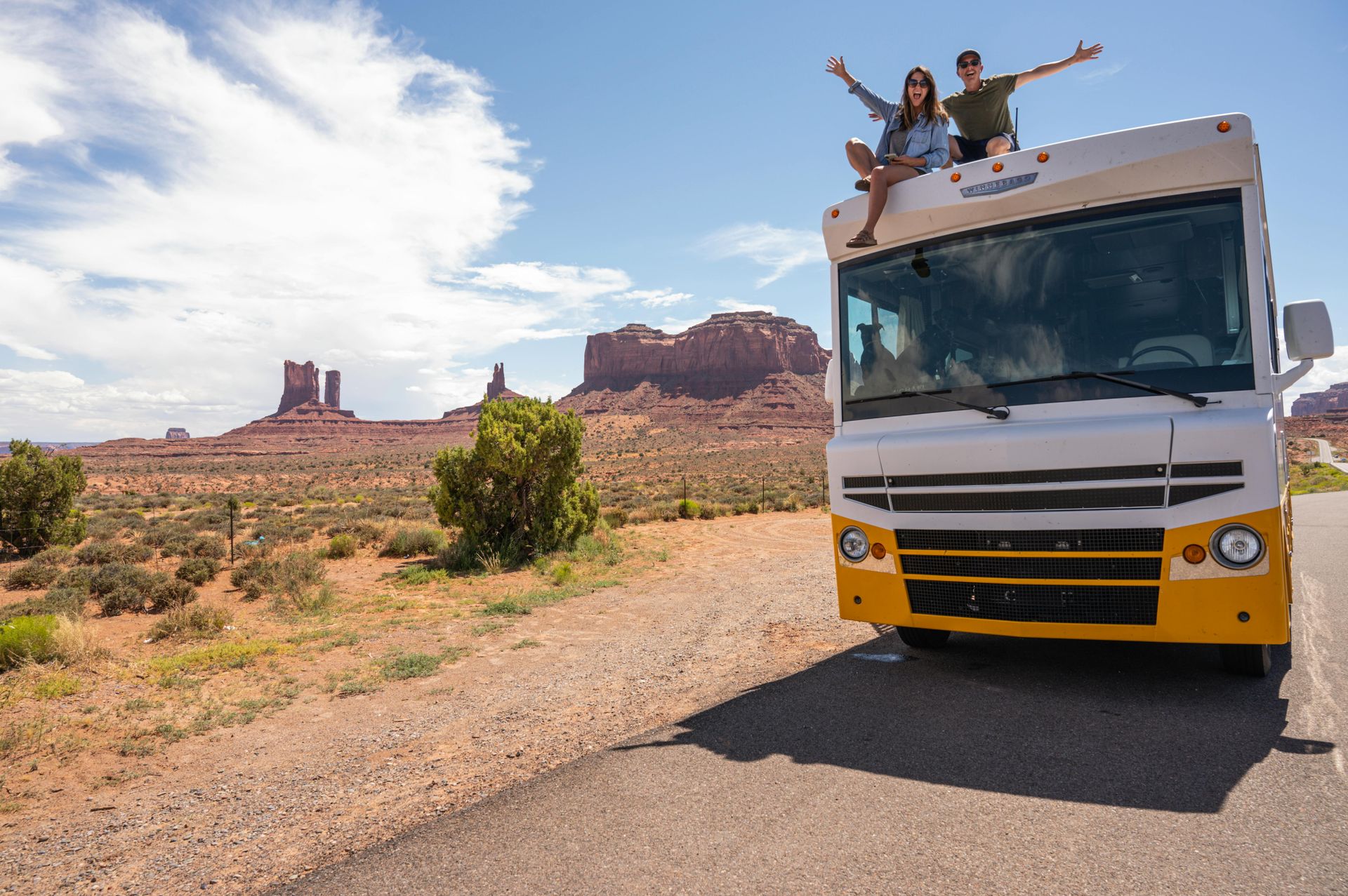Class A motorhome parked at Monument Valley Arizona with red rock buttes in background