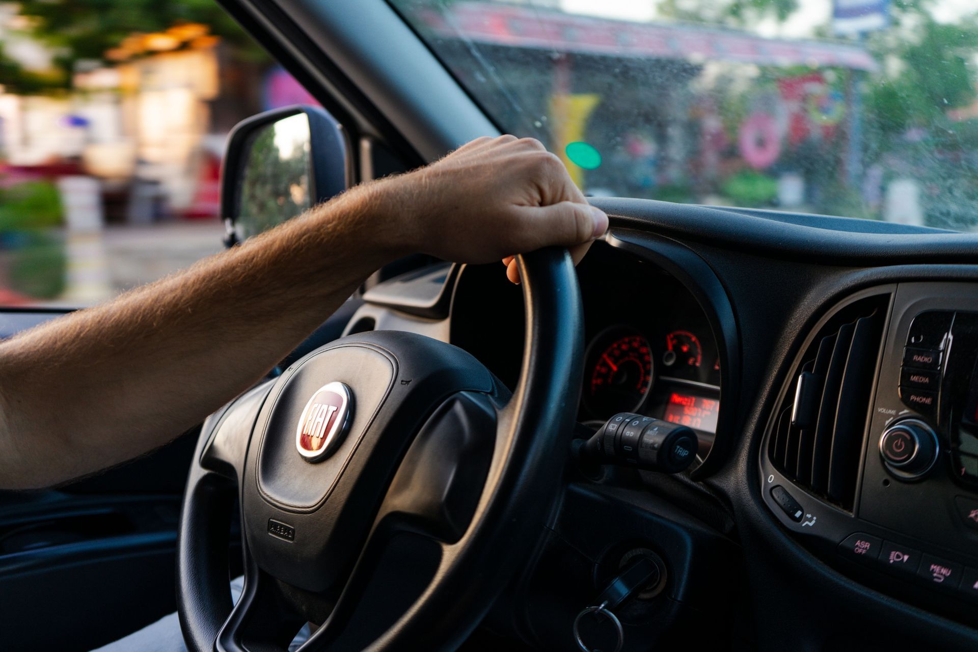 Driver with hands on the steering wheel in Arizona, weighing Progressive car insurance options and discounts