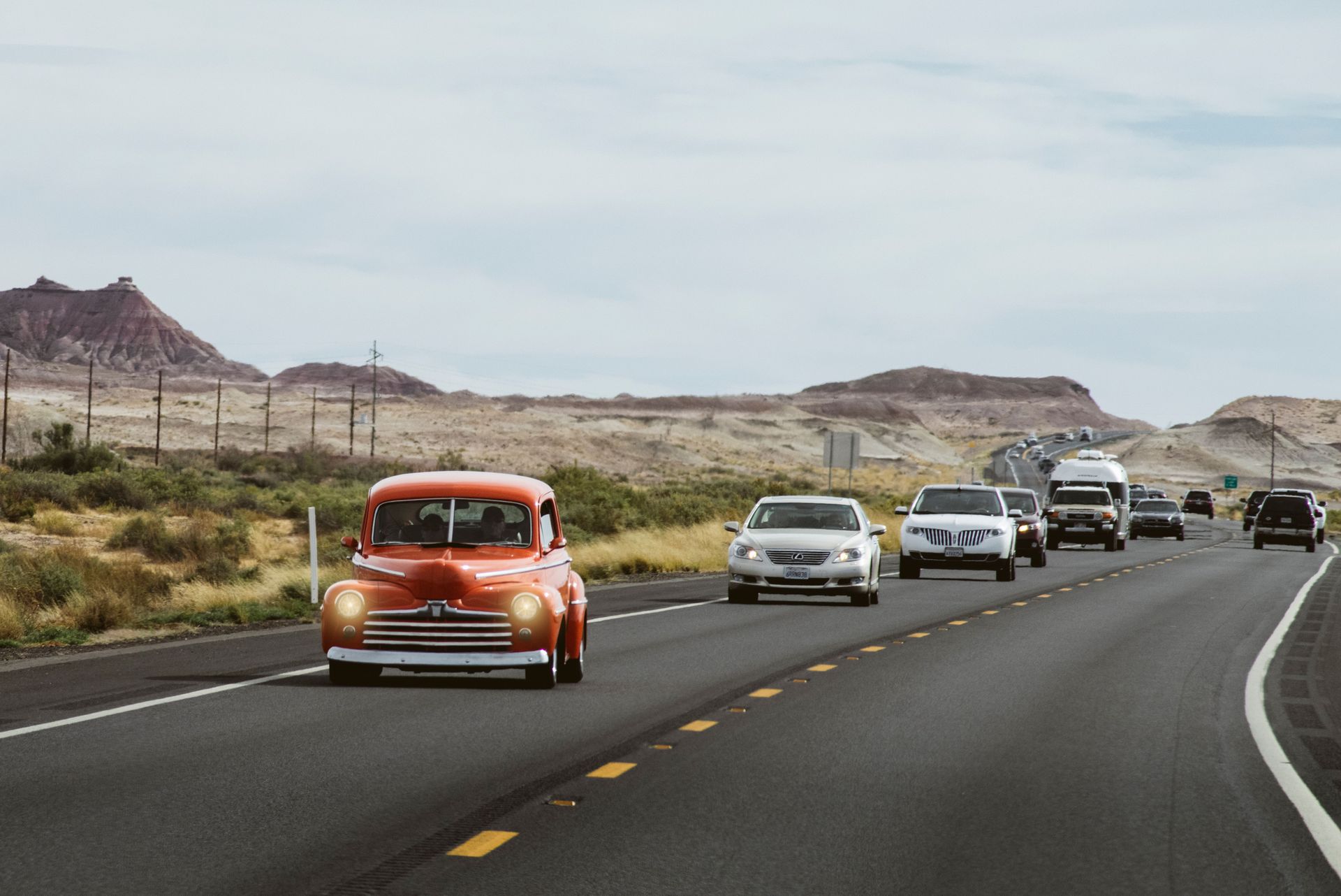 Cars driving on a desert highway in Arizona, showing Progressive car insurance for AZ drivers